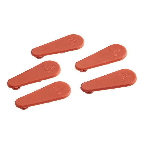 A close up of a pair of orange plastic Vigor Vent Closures.