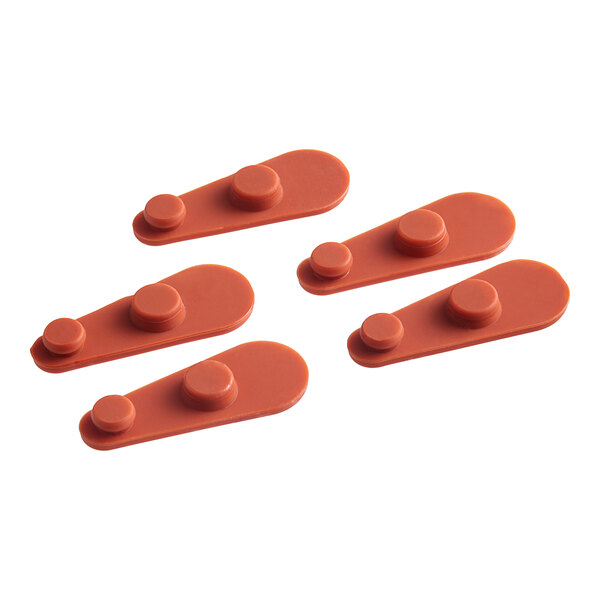 A group of orange plastic Vigor vent closures.