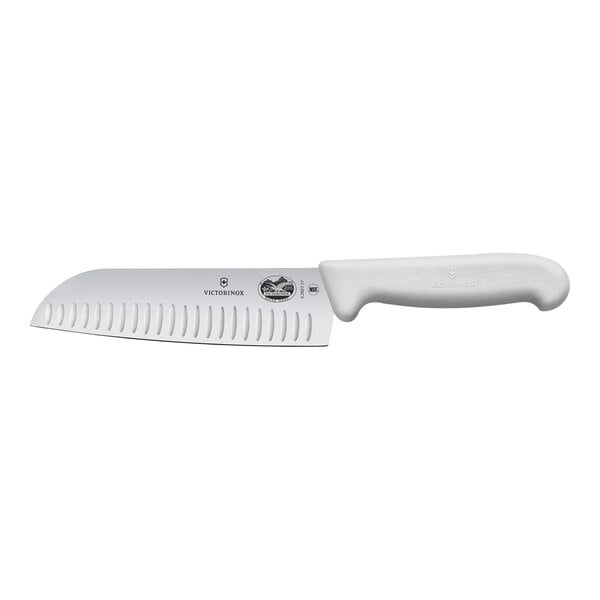 A Victorinox Santoku knife with a white handle.