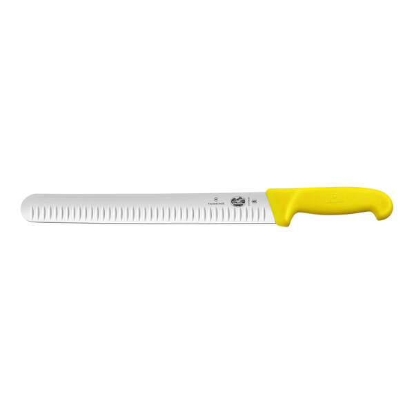 A Victorinox meat slicing knife with a yellow handle and a granton edge.