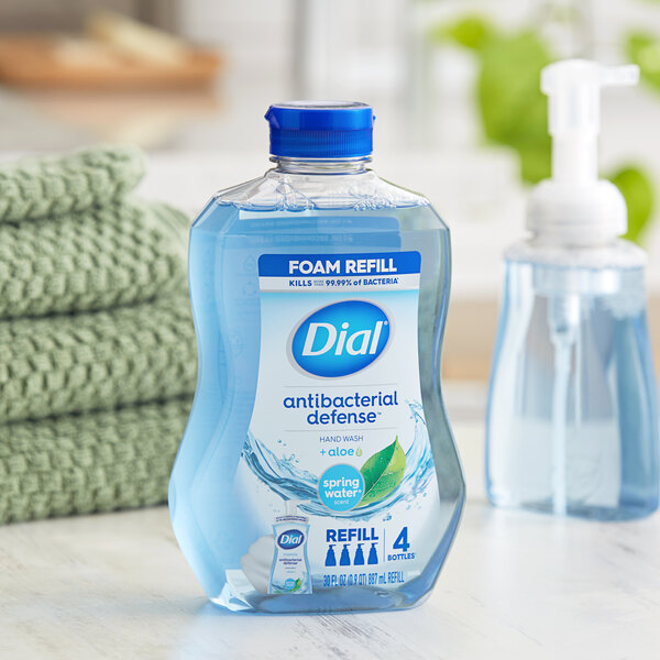 A close-up of a Dial Spring Water foaming hand soap refill bottle.