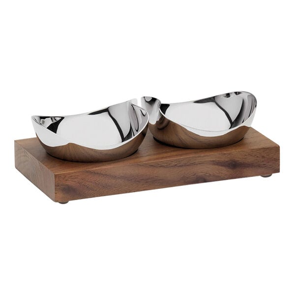 A Robert Welch walnut condiment server with two stainless steel bowls on a wood stand.