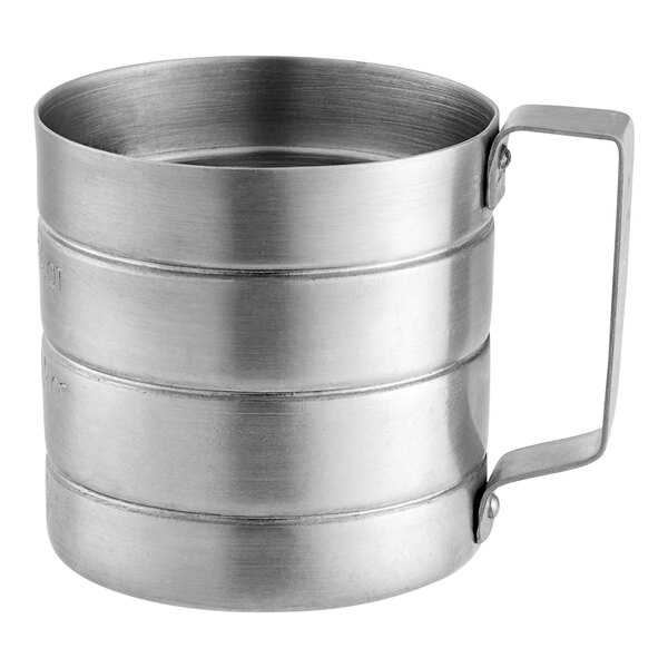 A white aluminum measuring cup with a handle.