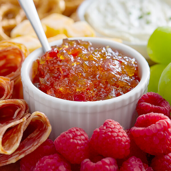 A bowl of TABASCO Pepper Jelly with fruit.