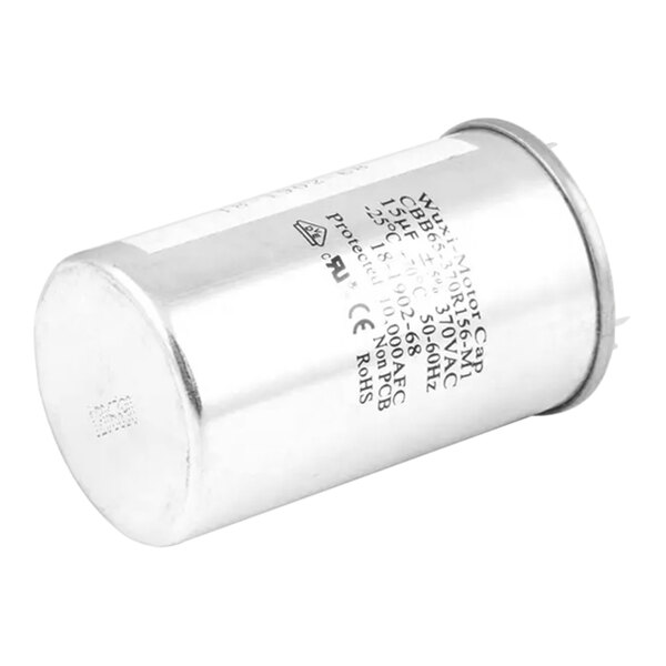 A silver capacitor with black text on a label.