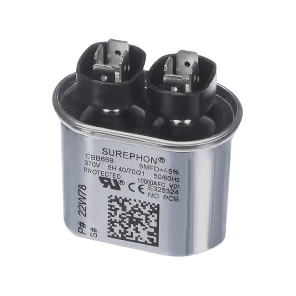 A silver Lennox oval capacitor with black and white text and two wires.