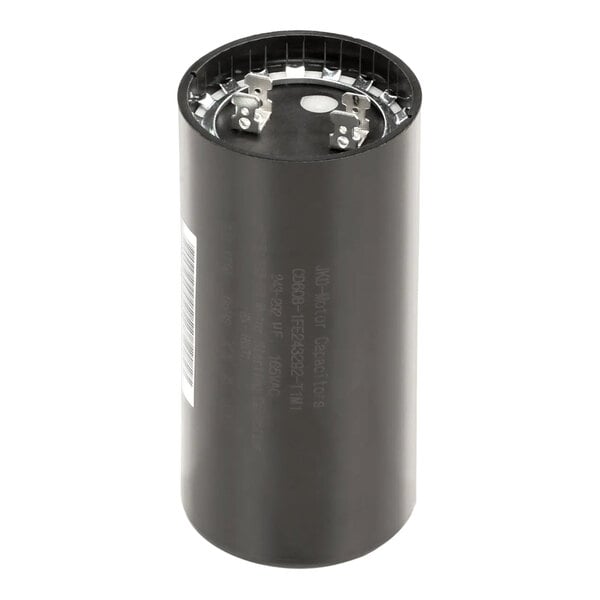 A close-up of a black cylinder with metal capacitor on top.