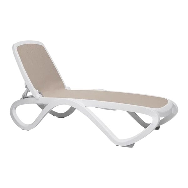 A white chaise lounge chair with tan cushions.