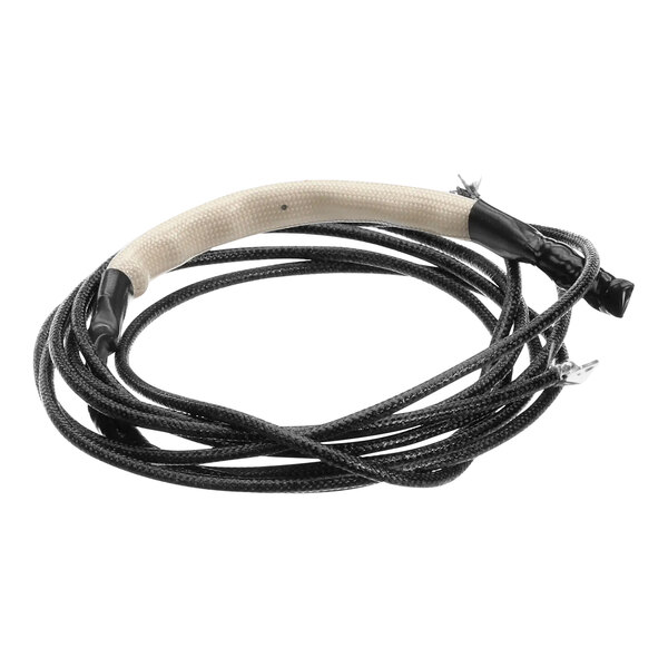 A black and white cable with a white wire plugged into a Fetco thermal circuit breaker.