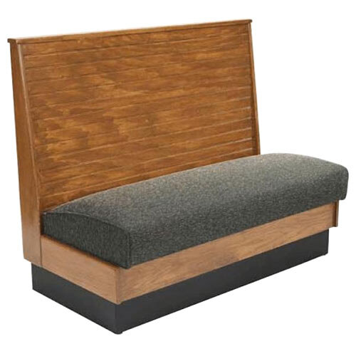 An American Tables & Seating wood wall bench with a grey cushion and bead board back.