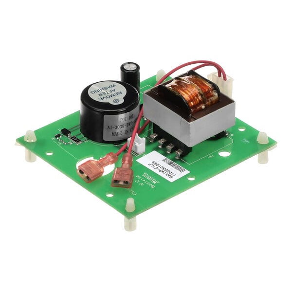A green Garland / US Range digital timer circuit board with black and white objects.
