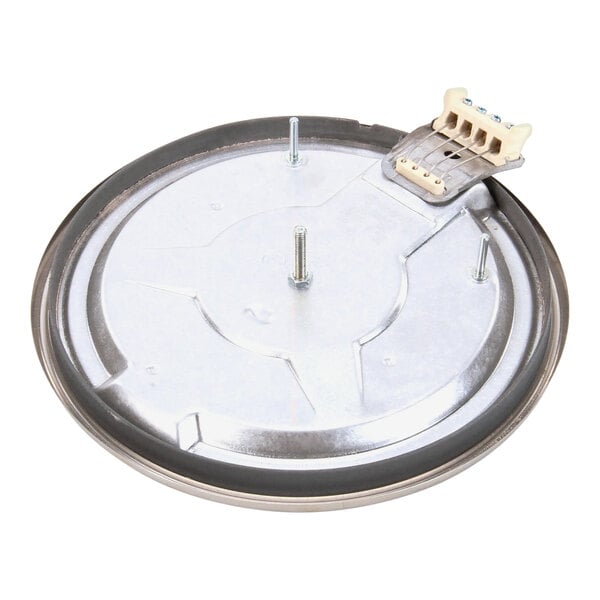A circular metal Vollrath stove plate element with a screw.