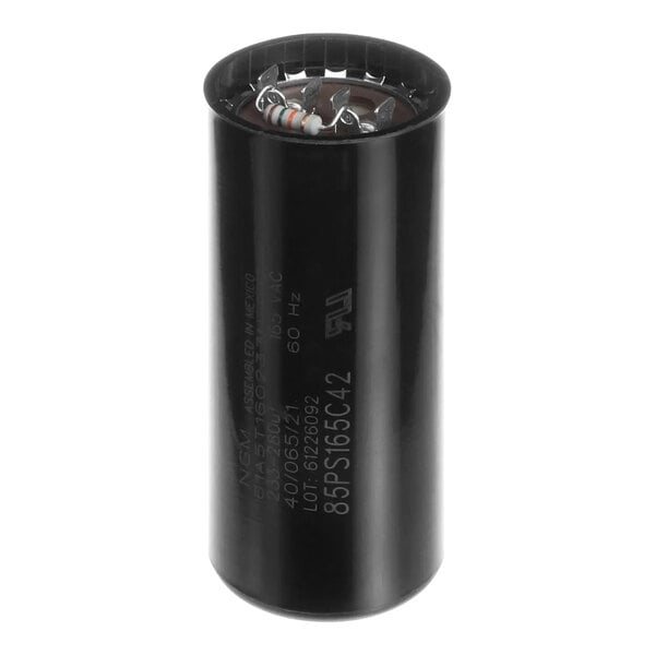 A black cylindrical Follett Corporation start capacitor.