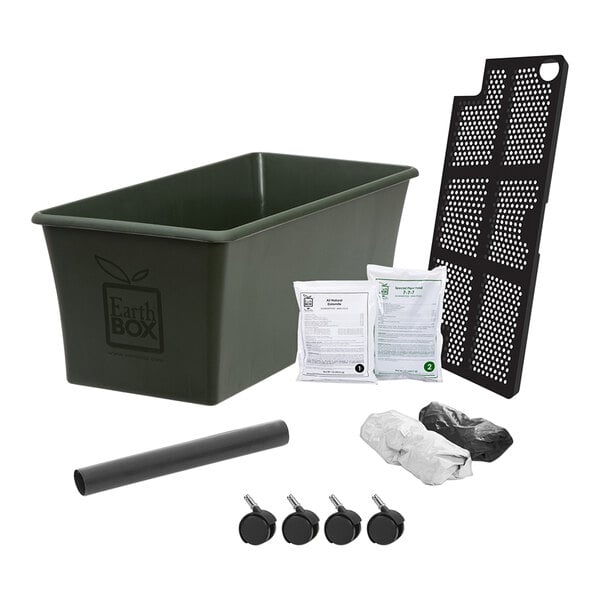 An EarthBox green plastic planter with accessories including black and white plastic bags.