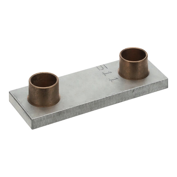 A metal plate with two brass cups on it.