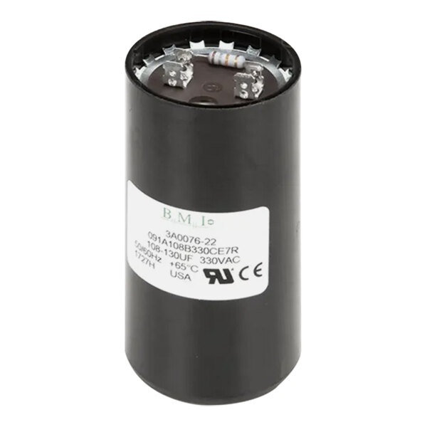 A black round capacitor with a white label.