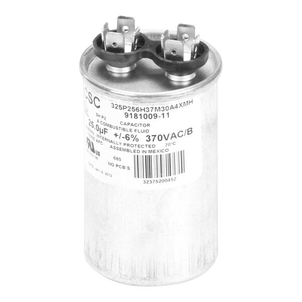 A close-up of a round silver Ice-O-Matic capacitor with black metal caps.