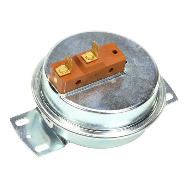 A round metal Lennox pressure switch with a brown and gold rectangular object on it.
