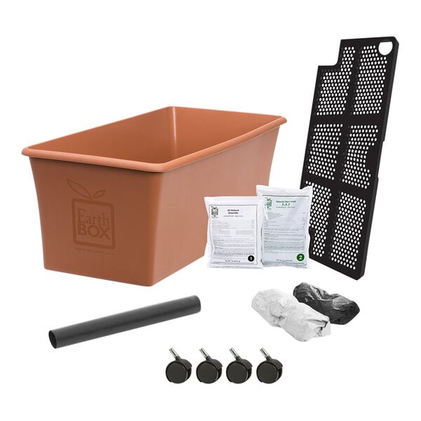 An EarthBox Original Terra Garden Kit in a brown plastic container with a black plastic tray and white plastic bag.