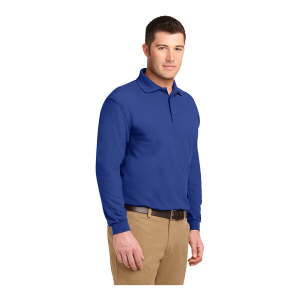 A man wearing a Port Authority® royal blue long sleeve polo shirt.