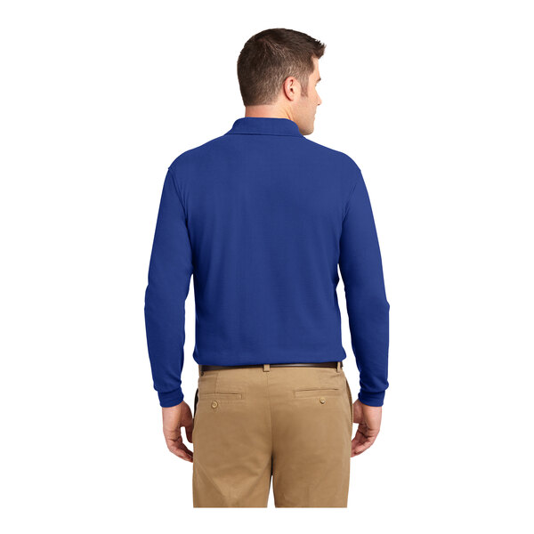A man wearing a Port Authority® royal blue long sleeved polo shirt.