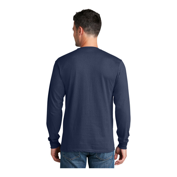 A man wearing a Port & Company navy blue long sleeve t-shirt.