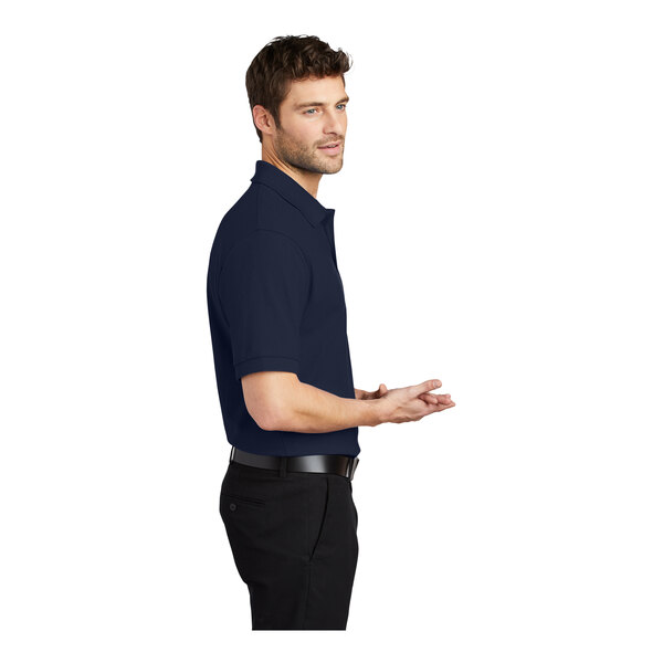 A man in a navy Port Authority® silk touch pique polo shirt.