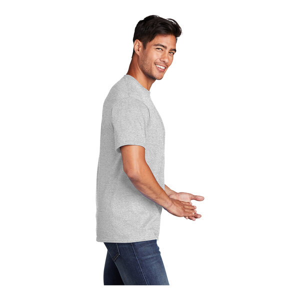A man in a medium Port & Company ash grey short sleeve t-shirt smiling.