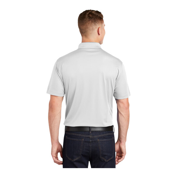 A man wearing a white Sport-Tek short sleeve polo shirt.