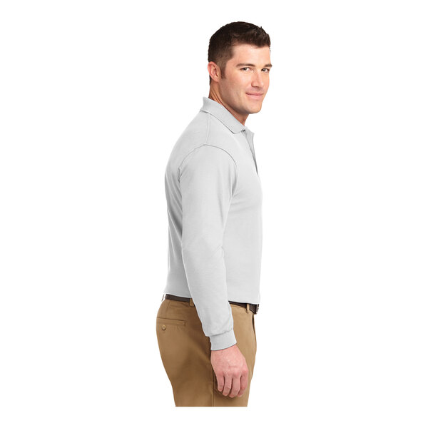 A man wearing a Port Authority white long sleeve polo shirt.