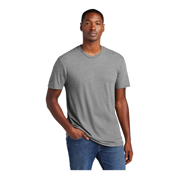 A man wearing a District unisex gray short sleeve t-shirt.