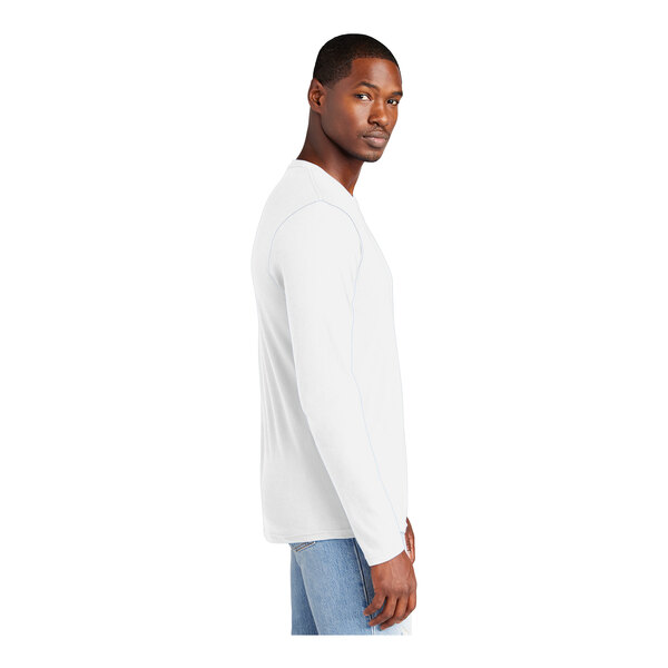 A man wearing a white District long sleeve T-shirt.