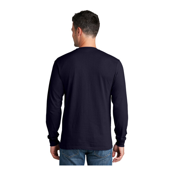 A man wearing a Port & Company True Navy long sleeve shirt.