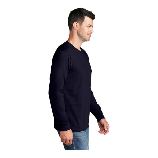 A man wearing a Port & Company True Navy long sleeve shirt.