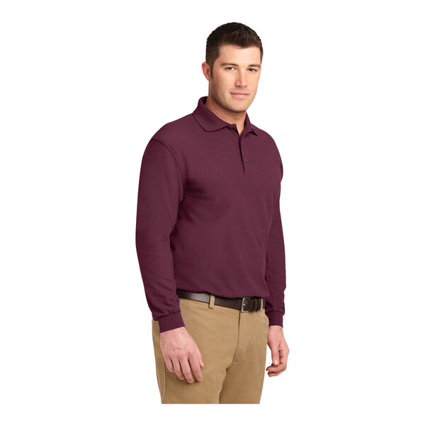 A man wearing a Port Authority burgundy long sleeve polo.