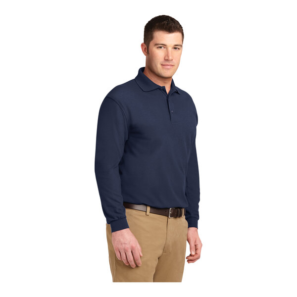 A close-up of a man wearing a navy Port Authority® long sleeve polo shirt.