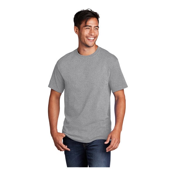 A man wearing a Port & Company athletic heather grey short sleeve t-shirt.