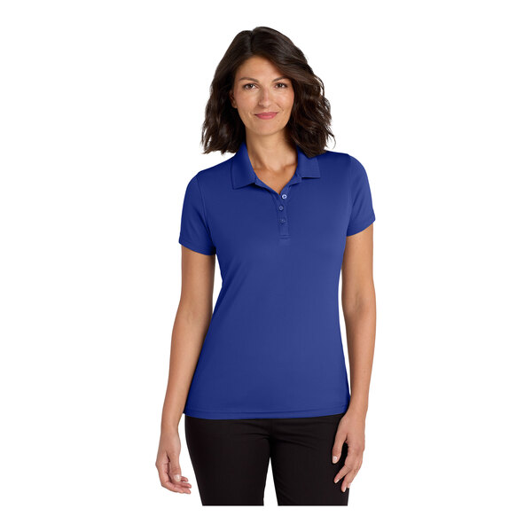 A woman wearing a blue Port Authority polo shirt with a black collar.