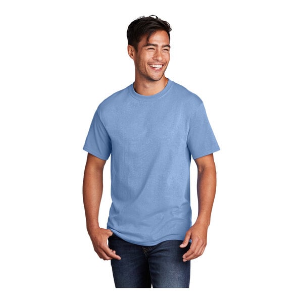 A man wearing a light blue Port & Company short sleeve t-shirt.