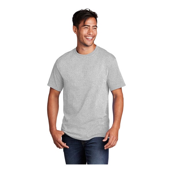 A man smiling and wearing an extra large Port & Company short sleeve t-shirt in ash grey.