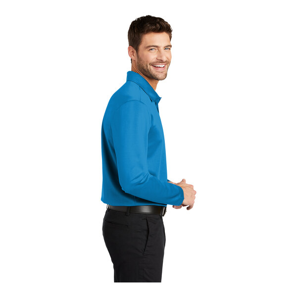 A man wearing an extra large Port Authority Brilliant Blue long sleeve polo shirt.