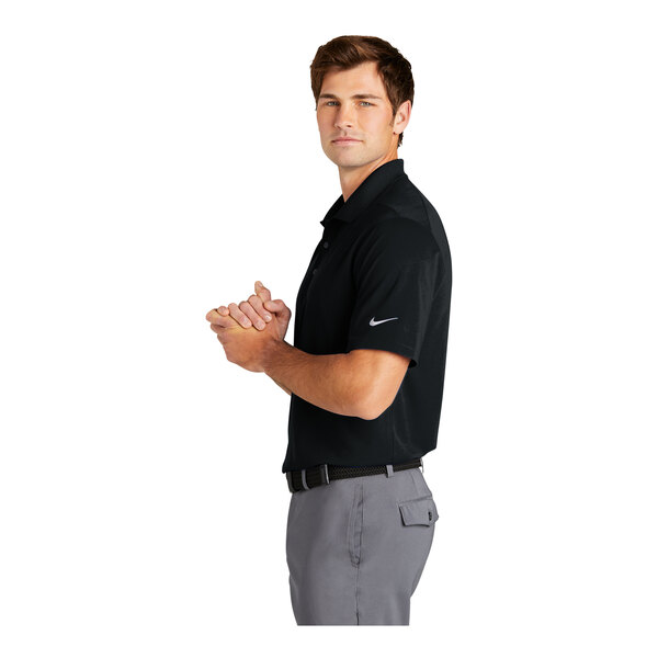 A man wearing a black Nike Dri-Fit polo shirt.