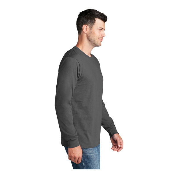 A man wearing a Port & Company long sleeve t-shirt.