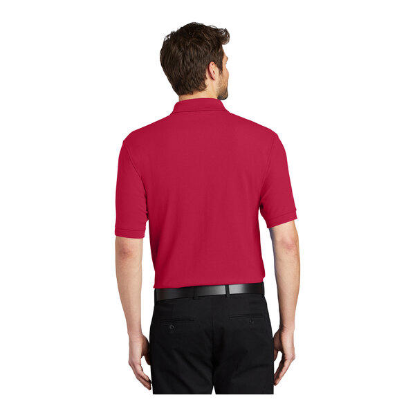 A man wearing a red Port Authority® silk touch polo.