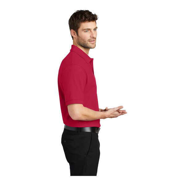 A man wearing a red Port Authority® polo shirt.