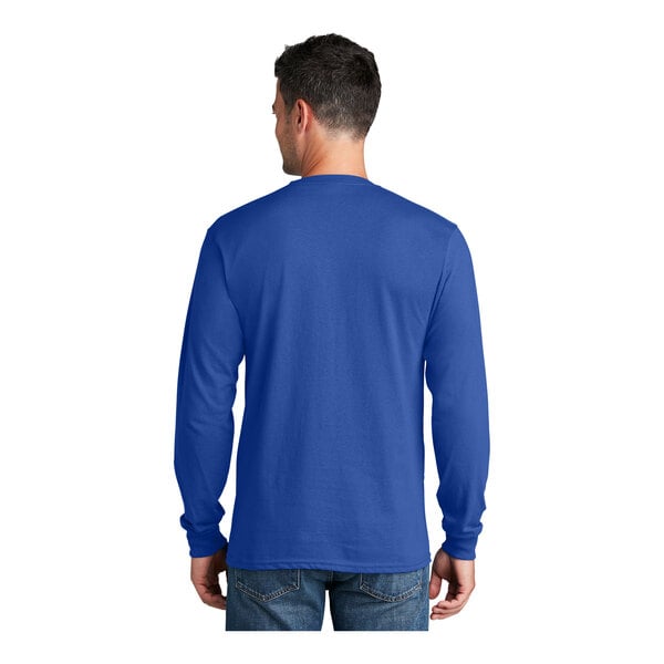 A man wearing a royal blue Port & Company long sleeve shirt.