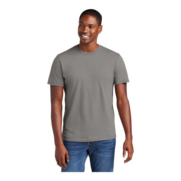 A man wearing a District® gray combed ring-spun cotton T-shirt.