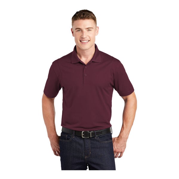 A man wearing a maroon Sport-Tek polo shirt.