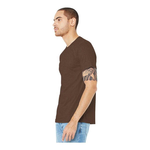 A man wearing a heather brown Bella + Canvas T-shirt.