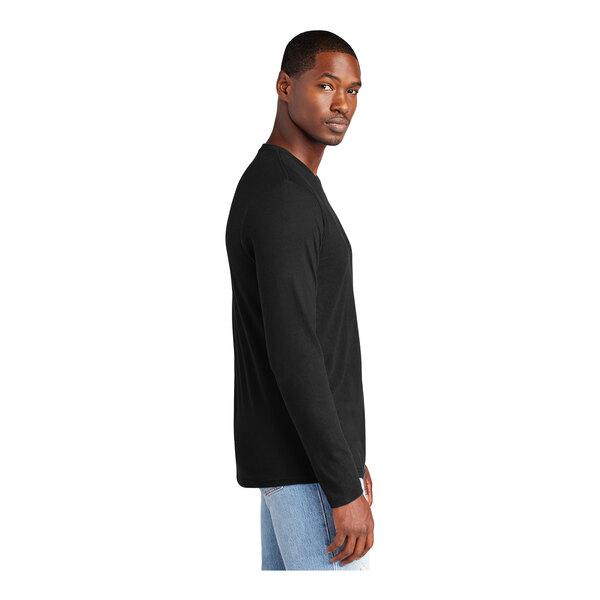 A man wearing a black District long sleeve t-shirt.